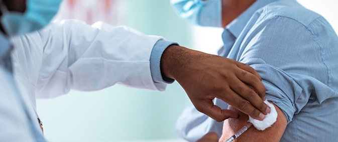 Doctor giving patient flu shot