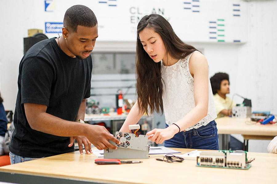 Two students work on a project together in a lab.