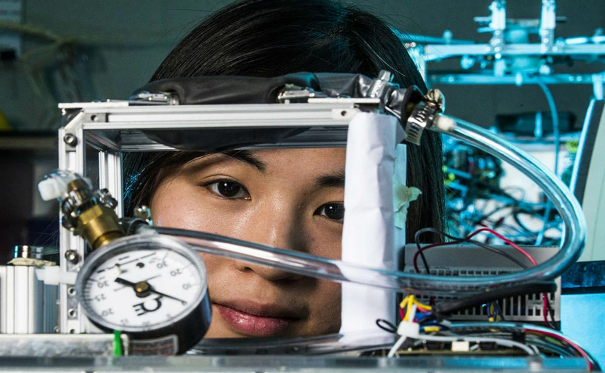 Electrical Engineering student with engineering equipment in lab