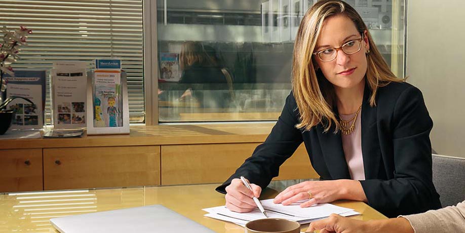 Graduate students working on papers at desk in office