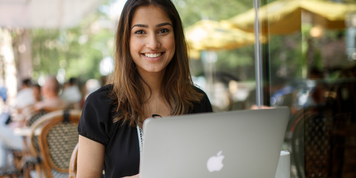 Person sitting at a table with laptop