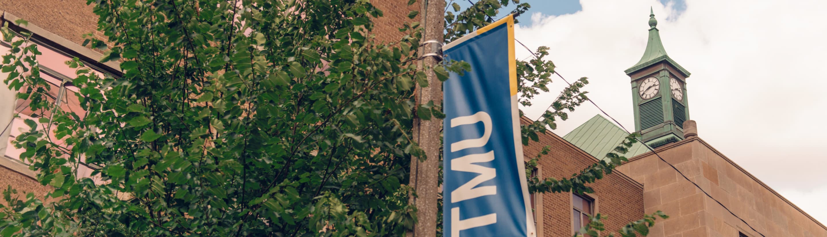 TMU banner in front of the clock tower