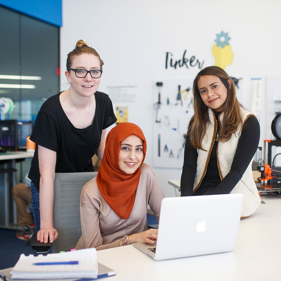 Three students work together at the Digital Media Experience Lab (DME) in SLC.