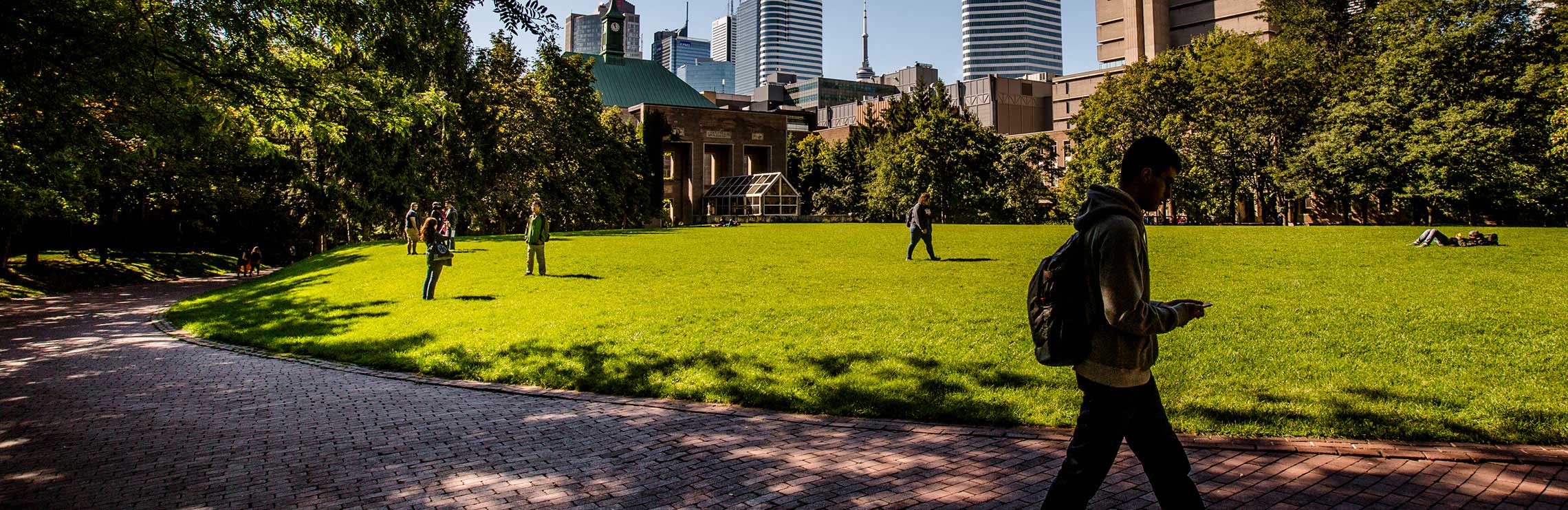 People walking through the Quad on a sunny day.