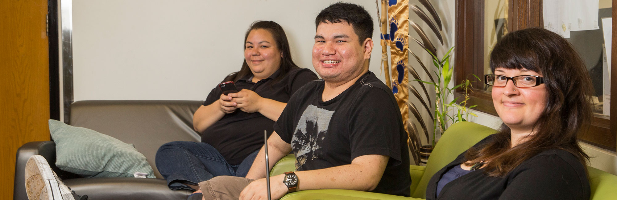 Three diverse Indigenous folks posing for the camera