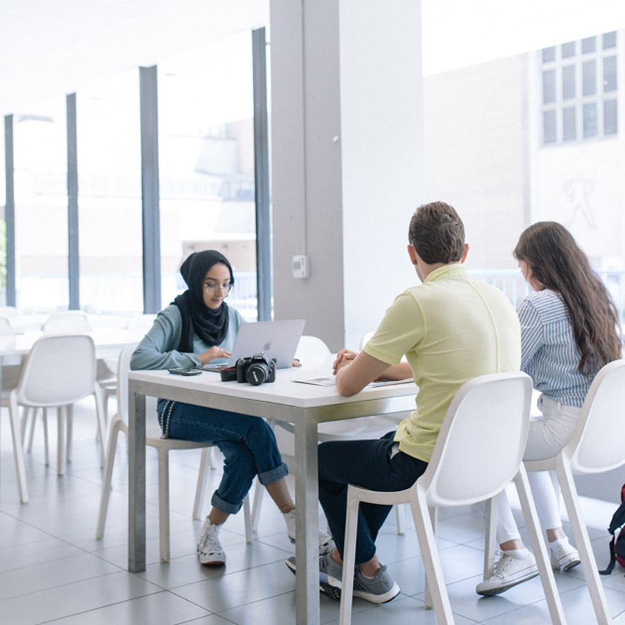 A group of students working together outside the ServiceHub.