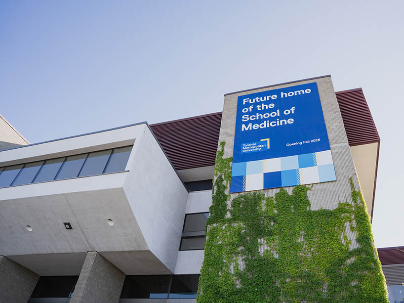 A large banner on the side of a building that reads “future home of the School of Medicine”