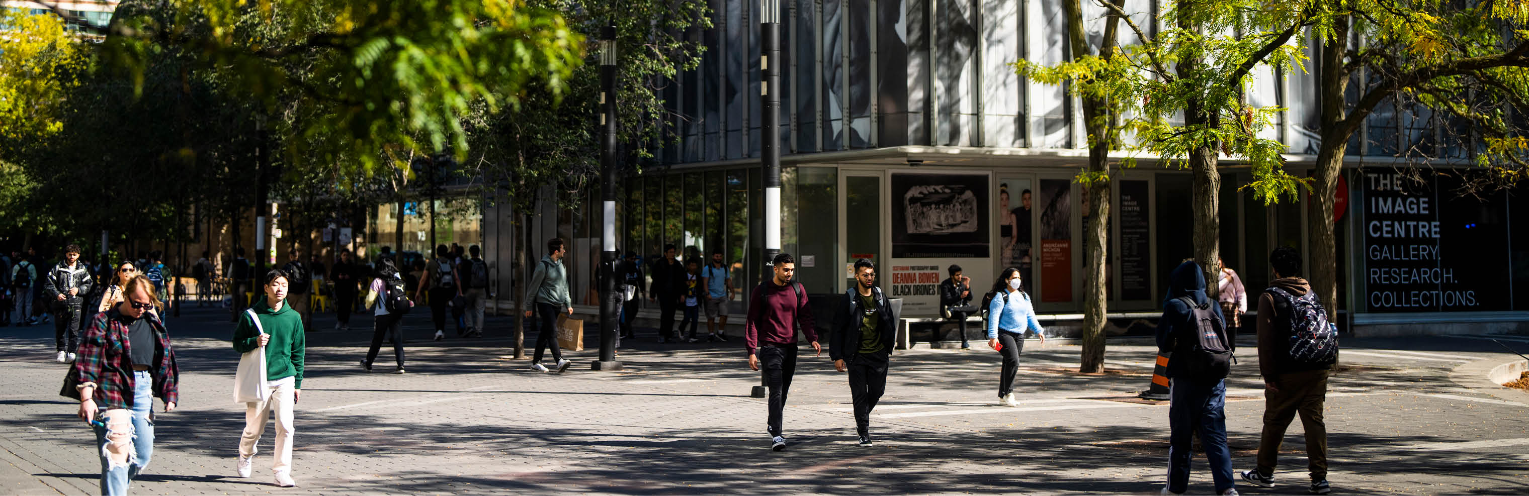 TMU community members walking on Gould St, Image Arts building in the background.