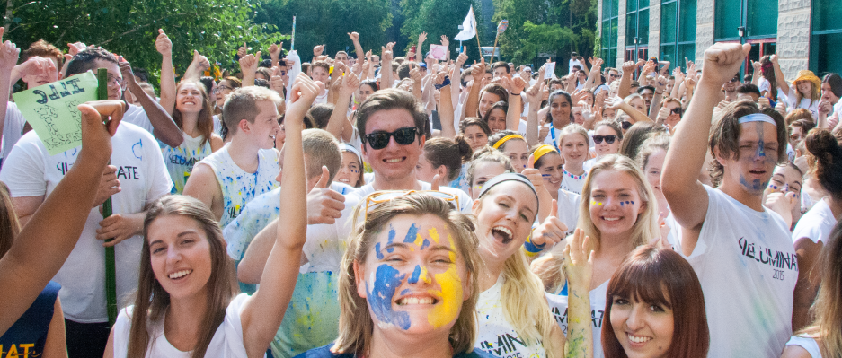 Students smiling and cheering in Pitman Quad