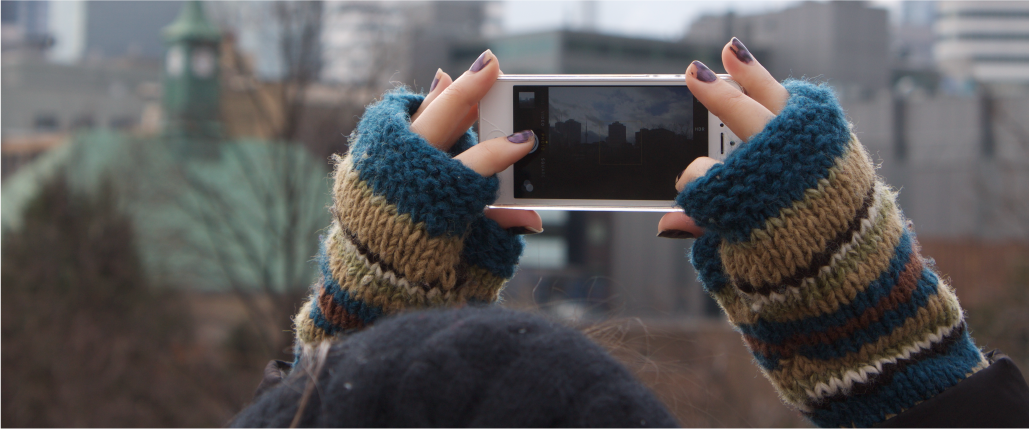 Student taking photograph of the city